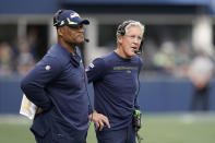 Seattle Seahawks head coach Pete Carroll, right, stands with defensive coordinator Ken Norton Jr., left, during the first half of an NFL football game against the Tennessee Titans, Sunday, Sept. 19, 2021, in Seattle. (AP Photo/Elaine Thompson)