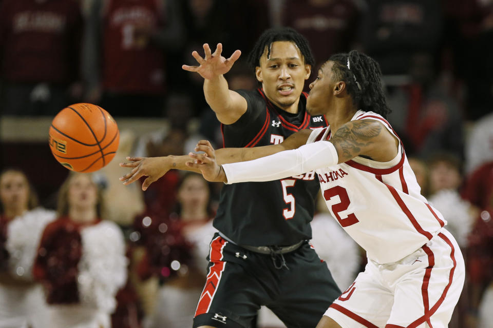 Oklahoma guard Javian McCollum (2) passes the ball as Texas Tech guard Darrion Williams (5) defends during the first half of an NCAA college basketball game, Saturday, Jan. 27, 2024, in Norman, Okla. (AP Photo/Nate Billings)