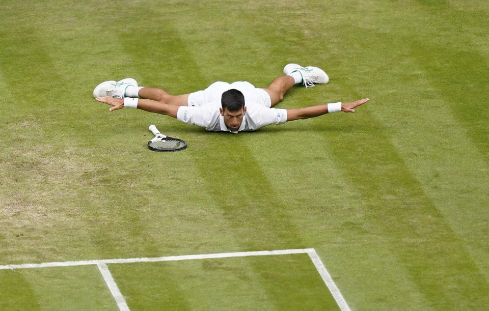 Serbia's Novak Djokovic reacts after making a passing shot to Italy's Jannik Sinner in a men's singles quarterfinal match on day nine of the Wimbledon tennis championships in London, Tuesday, July 5, 2022. (AP Photo/Alberto Pezzali)