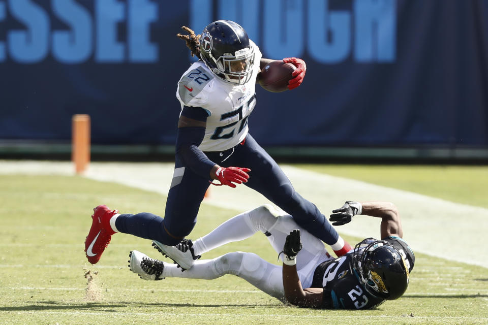 Tennessee Titans running back Derrick Henry (22) runs past Jacksonville Jaguars cornerback C.J. Henderson (23) in the second half of an NFL football game Sunday, Sept. 20, 2020, in Nashville, Tenn. (AP Photo/Wade Payne)