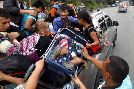 Honduran migrants, part of a caravan trying to reach the U.S., go up for a pick up during a new leg of their travel in Zacapa, Guatemala October 17, 2018. REUTERS/Edgard Garrido