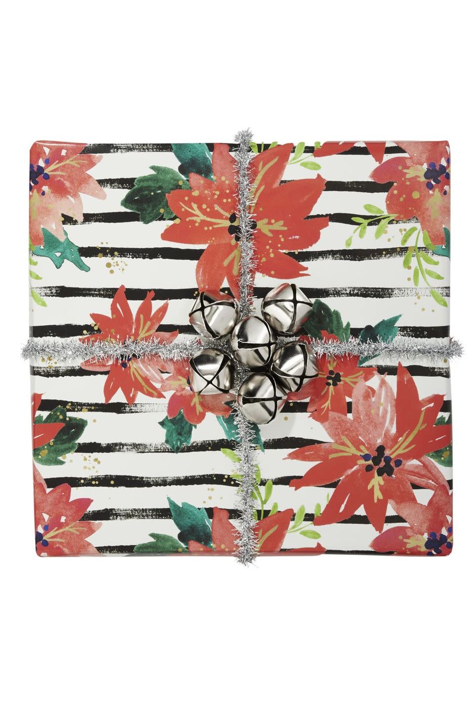 <p>This gorgeous poinsettia wrapping paper is complemented with shiny silver bells. The sparkly wire and jingly bells can be recreated on just about any style of wrapping paper.</p>