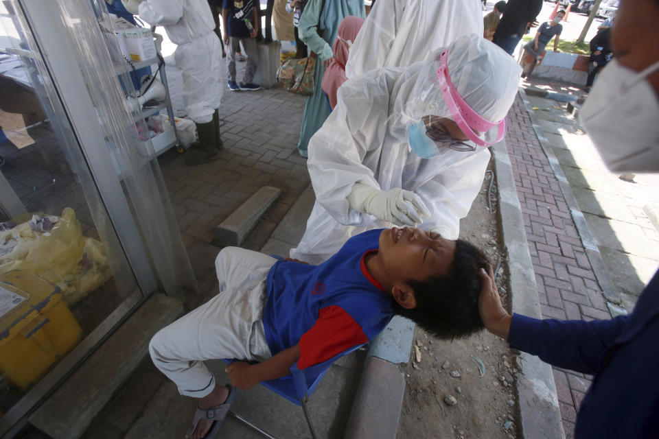 A ten years old boy gets a coronavirus test at the North Sumatra University hospital in Medan, North Sumatra, Indonesia, Thursday, July 22, 2021. (AP Photo/Binsar Bakkara)