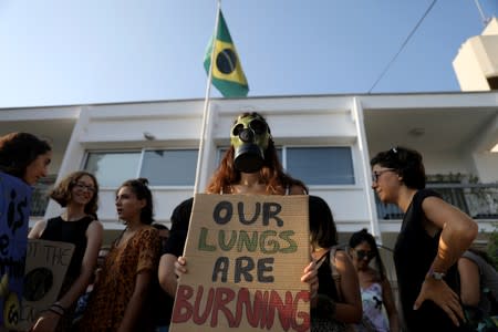 Climate activists attend a protest outside Brazil's embassy due to the wildfires at Amazon rainforest, in Nicosia