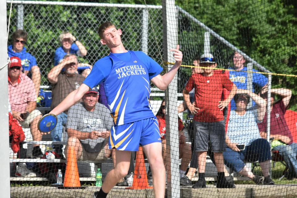 Mitchell freshman Nate Robertson lets it fly at the 2022 Bloomington North Boys' Track and Field Regional.