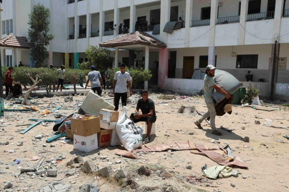 Palestinians leave the school after an airstrike killed at least 30 people (Reuters)