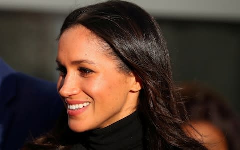 Meghan Markle leaves after visiting a school with her fiancee Britain's Prince Harry in Nottingham - Credit: Reuters