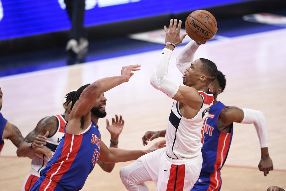 Washington Wizards guard Russell Westbrook, right, goes to the basket against Detroit Pistons center Jahlil Okafor, left, during the first half of an NBA basketball game, Saturday, April 17, 2021, in Washington. (AP Photo/Nick Wass)