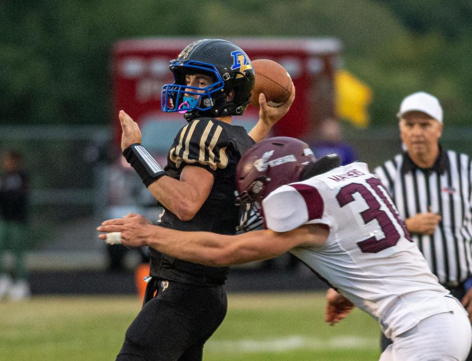 Du-Pec QB Cooper Hoffman tries to get a pass off before being sacked by Dakota's Conner Mathews in the first quarter of their game on Friday, Sep. 8, 2023, at Pecatonica.