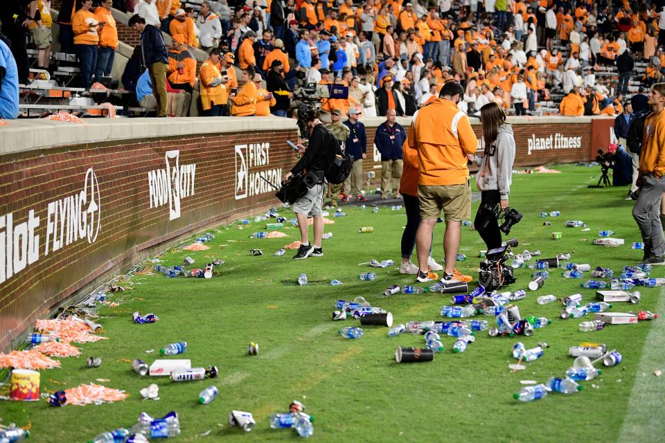 Trash litters the sidelines after it was ruled that Jacob Warren was a yard short of the first down marker on a fourth-and-24 play during the game between Tennessee and Ole Miss.