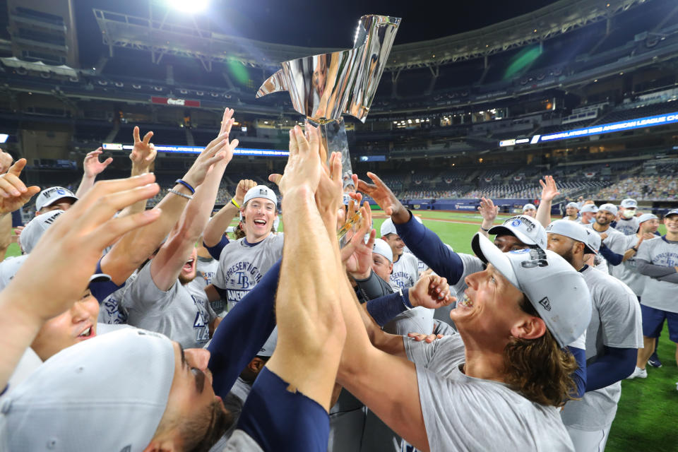 SAN DIEGO, CA - OCTOBER 17: Members of the Tampa Bay Rays celebrate with the 2020 American League Champions trophy after they win Game 7 of the ALCS 4-2 against the Houston Astros at Petco Park on Saturday, October 17, 2020 in San Diego, California. (Photo by Alex Trautwig/MLB Photos via Getty Images)