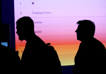 FILE PHOTO: Participants are silhouetted as they pass through the IOT (Internet of Things) Village during the Def Con hacker convention in Las Vegas, Nevada, U.S., July 29, 2017. REUTERS/Steve Marcus/File Photo