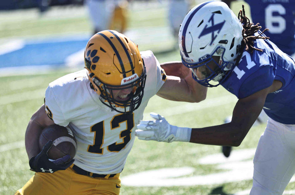 St. Xavier defensive back Macen Hall (17) tackles Cleveland St. Ignatius wide receiver Ryan Kennedy (13) during a football game between St. Ignatius and St. Xavier high schools Saturday, Oct. 15, 2022.