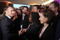 French President Emmanuel Macron greets employees at the French Microsoft headquarters in Issy-les-Moulineaux, outside Paris, Monday, May 13, 2024. Microsoft, which has been present in France for 41 years, is announcing a 4 billion euro investment this year, the largest to date in the country, to support French growth in the new artificial intelligence economy. (AP Photo/Thibault Camus, Pool)