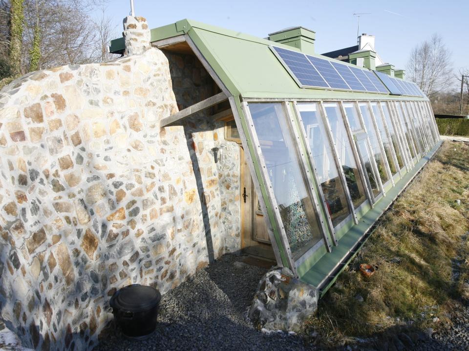 normandy earthship built into the side of a hill