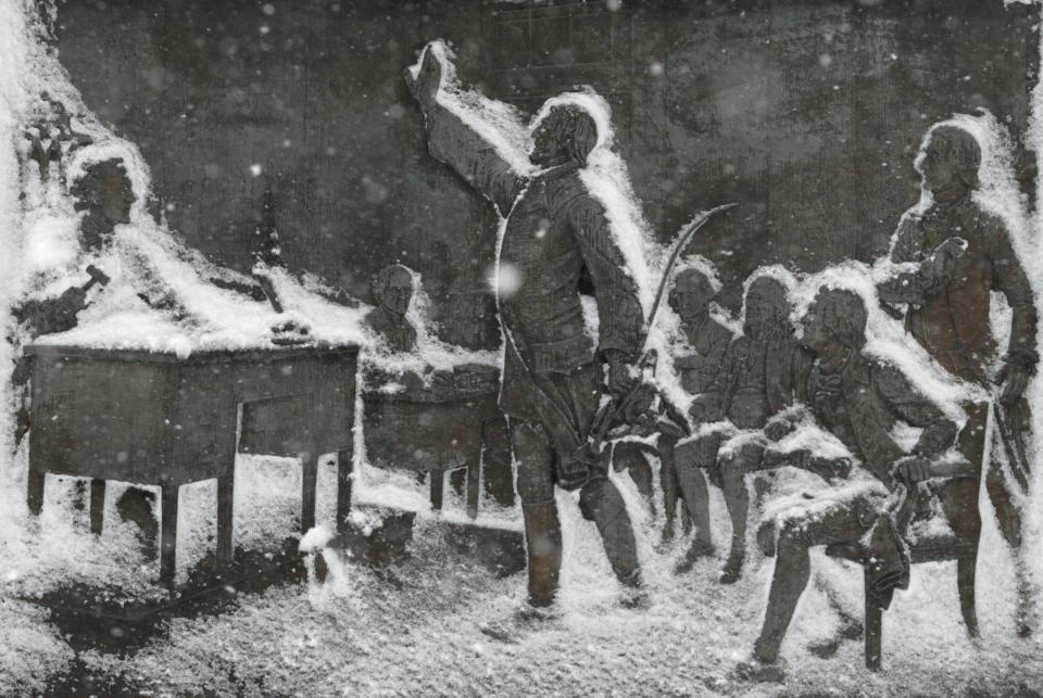 Caesar Rodney (center) has a frosty frame on his Rodney Square monument showing him casting his vote for independence after his famous ride as snow falls in Wilmington in this 2010 photo.