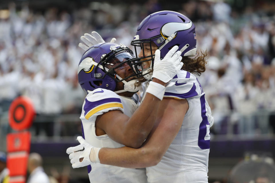 Minnesota Vikings tight end T.J. Hockenson celebrates with teammate Justin Jefferson, left, after catching a 12-yard touchdown pass during the first half of an NFL football game against the New York Giants, Saturday, Dec. 24, 2022, in Minneapolis. (AP Photo/Bruce Kluckhohn)