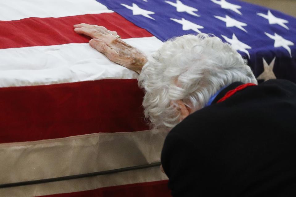 Annie Glenn rests her hand on her husband John Glenn's casket as he lies in honor, Friday, Dec. 16, 2016, in Columbus, Ohio. Glenn's home state and the nation began saying goodbye to the famed astronaut who died last week at the age of 95. (AP Photo/John Minchillo)