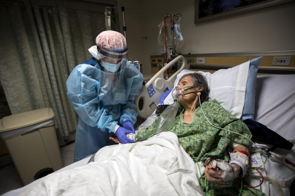 RN Ana Ramos, left, helps Margaret Gallegos-Capetello