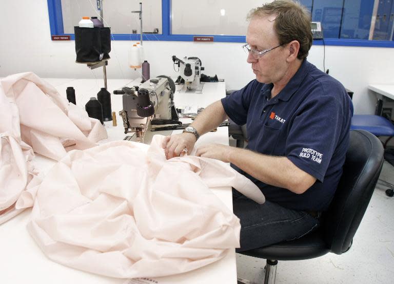 File photo of a Takata employee sewing an airbag at a crash-testing facility in Auburn Hills, Michigan