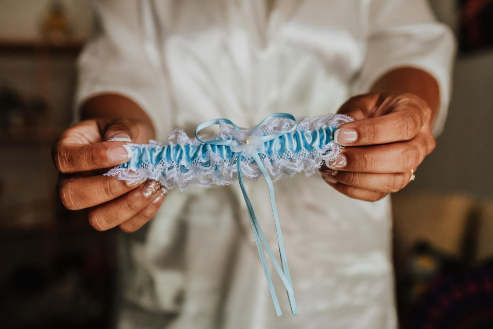 Someone holding a wedding garter