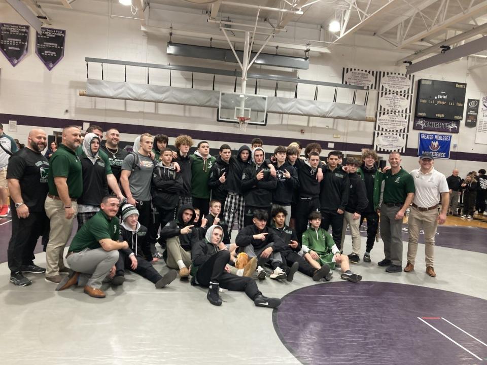 The St. Joseph wrestling team poses after beating Old Bridge and clinching the GMC Red Division on Jan. 18, 2023