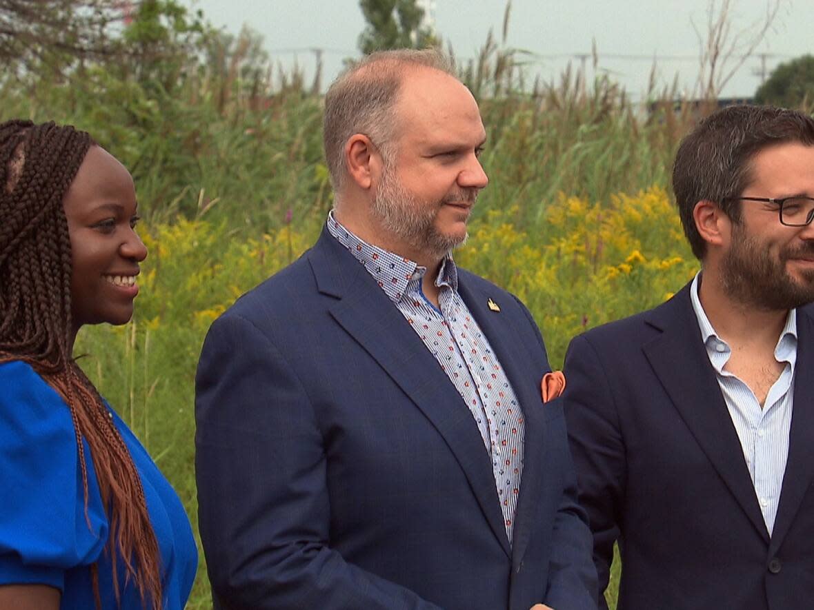 Montreal elected officials Gracia Kasoki Katahwa, left, Benoit Dorais, centre, and Robert Beaudry, made the announcement at the old racetrack on Monday.  (CBC - image credit)