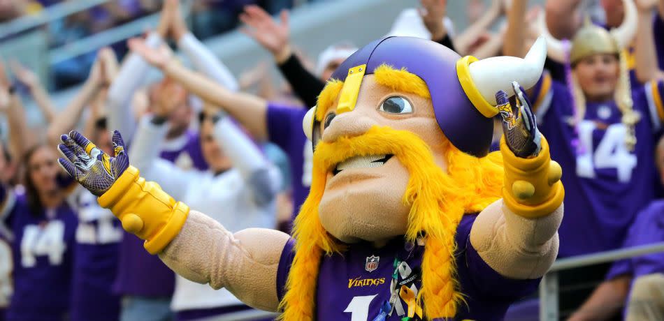 Minnesota Vikings mascot spreads his arms wide.