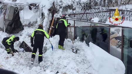 Firefighters work at Hotel Rigopiano in Farindola, central Italy, after it was hit by an avalanche, in this handout picture released on January 20, 2017 provided by Italy's Fire Fighters. Vigili del Fuoco/Handout via REUTERS
