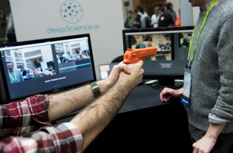 Elliot Hirsch of Deep Science holds a fake gun as he demonstrates the company's security system to automatically detect firearms and thieves