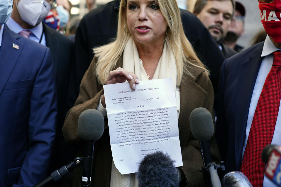 Former Florida Attorney General Pam Bondi displays a court order granting President Donald Trump's campaign more access to vote counting operations at the Pennsylvania Convention Center, Thursday, Nov. 5, 2020, in Philadelphia, following Tuesday's election. (AP Photo/Matt Slocum)