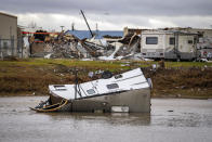 A camping trailer sits in a retention pond where a tornado was reported to pass along Mickey Gilley Blvd., near Fairmont Parkway, Tuesday, Jan. 24, 2023, in Pasadena, Texas. (Mark Mulligan/Houston Chronicle via AP)