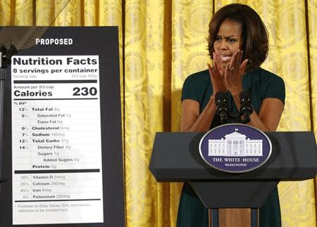 U.S. first lady Michelle Obama applauds as she unveils proposed updates to nutrition facts labels during remarks in the East Room of the White House in Washington, February 27, 2014. REUTERS/Jonathan Ernst