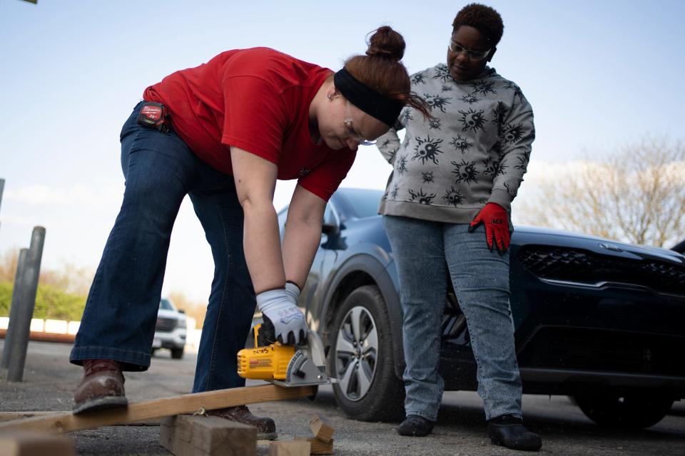 Cynthia Hard, of Bexley, left, gets her hands on a circular saw, while Courtney Grisby, of the West Side, watches during a Building Futures class. For the first time, the program that provides construction and safety training to members of underserved communities had an all-female class.