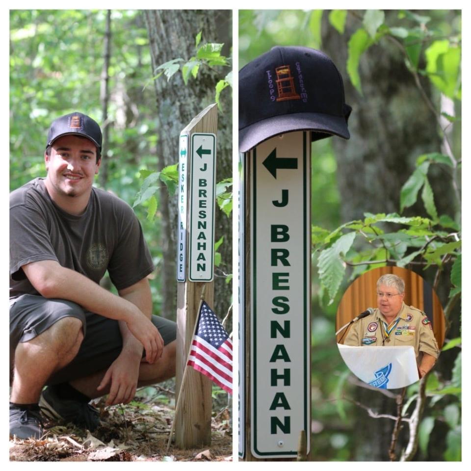 Michael Newton poses next to the trail sign in the Cummings Conservation Area that was erected in honor of longtime scoutmaster John Bresnahan.