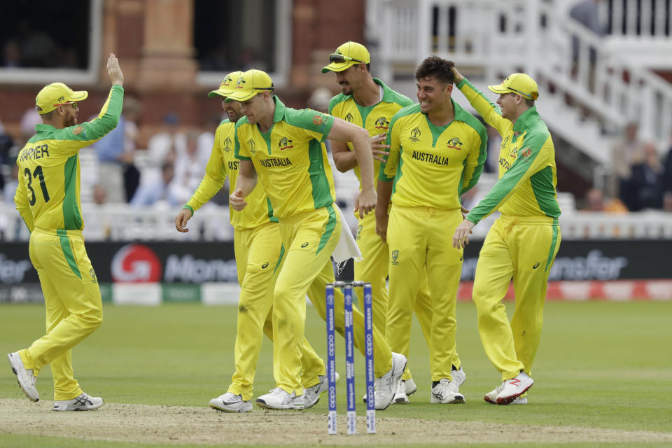 Australia's Marcus Stoinis, second right, celebrates taking the wicket of England's Jos Buttler during the Cricket World Cup match between England and Australia at Lord's cricket ground in London, Tuesday, June 25, 2019. (AP Photo/Matt Dunham)