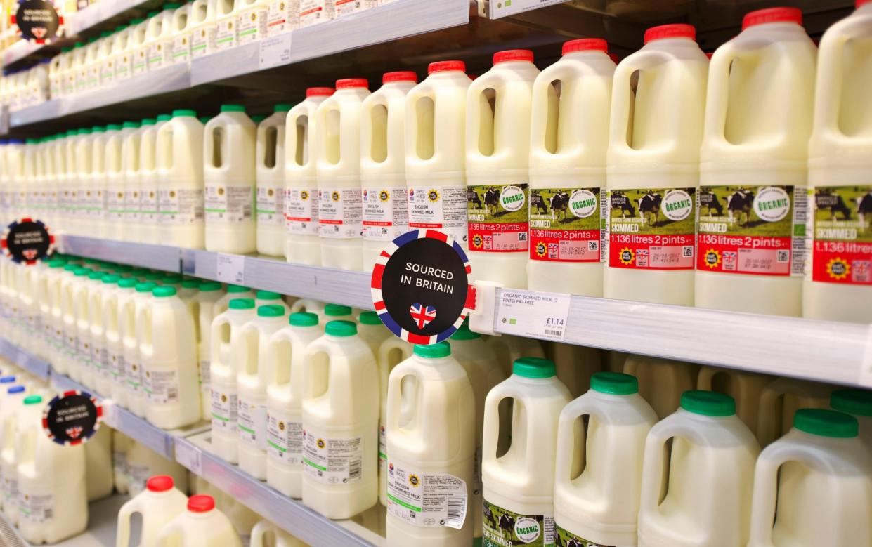 Fresh British milk on the shelves of a marks and spencer foodhall along with juice, fresh juices and smoothies - Julian Claxton/Alamy Stock Photo