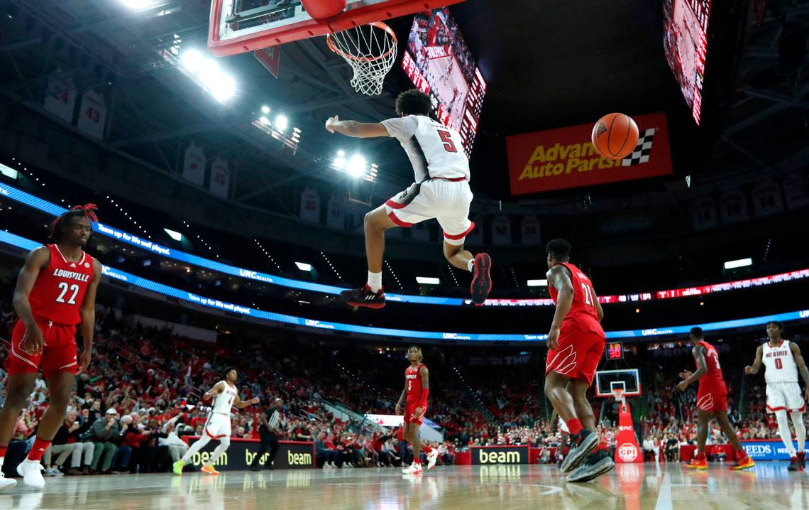 N.C. State’s Jack Clark (5) comes back down after slamming in two during N.C. State’s 76-64 victory over Louisville at PNC Arena in Raleigh, N.C., Thursday, Dec. 22, 2022.