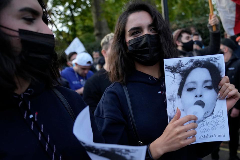 Demonstrators hold placards outside the Iranian Embassy in London (AP)