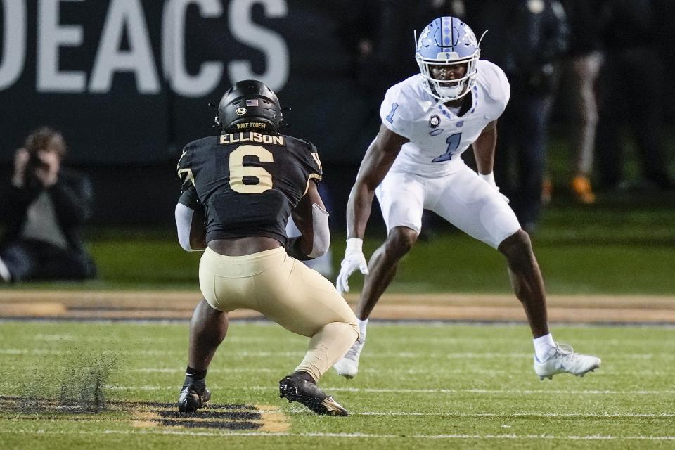 Nov 12, 2022; Winston-Salem, North Carolina; Wake Forest Demon Deacons running back Justice Ellison (6) tries to evade North Carolina Tar Heels defensive back Tony Grimes (1) during the second half at Truist Field. Jim Dedmon-USA TODAY Sports