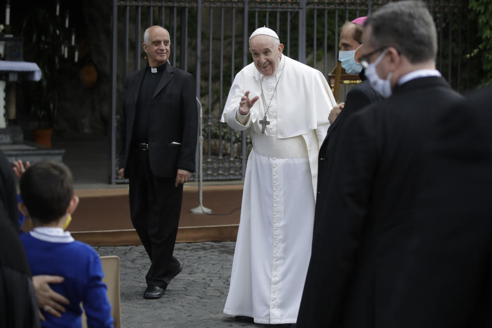 Pope Francis waves as he leaves after a rosary in Vatican gardens Saturday, May 30, 2020. Pope Francis is reciting a special prayer for the end of the coronavirus pandemic surrounded by a representative sampling of people on the front lines in his biggest post-lockdown gathering to date. (AP Photo/Alessandra Tarantino, pool)