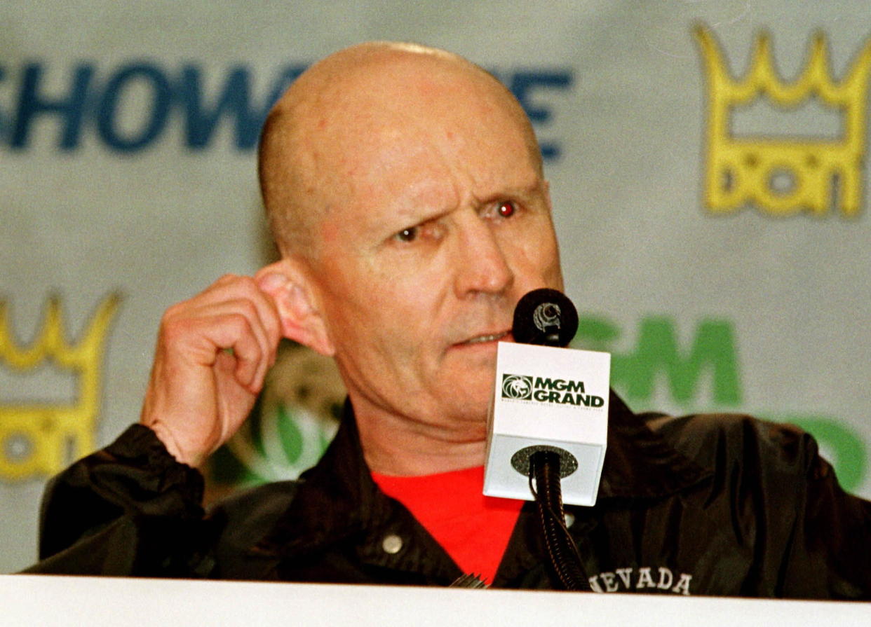 Referee Mills Lane holds his ear as he explains why he stopped the fight after Mike Tyson bit Evander Holyfield's ear during the third round of their WBA heavyweight championship fight in Las Vegas on June 28. The fight was stopped after Tyson was disqualified.

SPORT BOXING