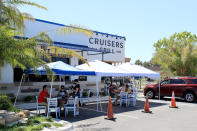 JACKSONVILLE BEACH, FLORIDA - MAY 04: People are seen dining outside at Cruisers Grill as the state of Florida enters phase one of the plan to reopen the state on May 04, 2020 in Jacksonville Beach, Florida. Restaurants, retailers, beaches and some state parks reopen today with caveats, as the state continues to ease restrictions put in place to contain the coronavirus (COVID-19). (Photo by Sam Greenwood/Getty Images)