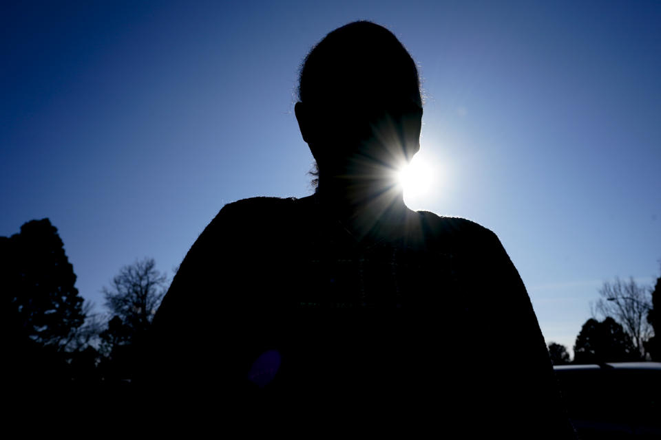 An American nurse who was visiting her family in Ethiopia's Tigray region and witnessed the conflict there but escaped back to the U.S. poses for a photograph outside her home in Colorado Monday, Feb. 8, 2021. Rare witness accounts are illuminating the shadowy conflict in Tigray, which is largely cut off from the outside world as fighting enters a fourth month in a region of 6 million people. (AP Photo/David Zalubowski)