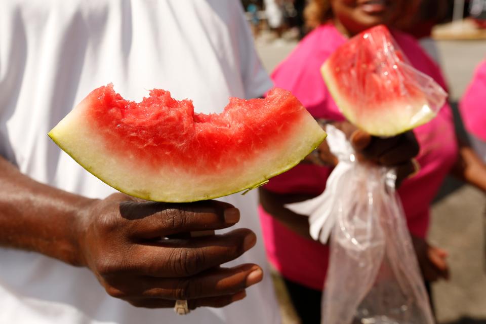 Watermelon on a stick was a hot commodity at the Hot Corner Festival in downtown Athens, Ga., on June 11.