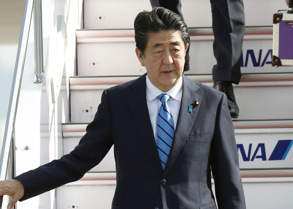 Japanese Prime Minister Shinzo Abe arrives at Haneda airport in Tokyo Friday morning, June 14, 2019 after a two-day visit to Iran.  A Japanese-owned oil tanker was attacked near the Strait of Hormuz on Thursday. (Naoya Osato/Kyodo News via AP)