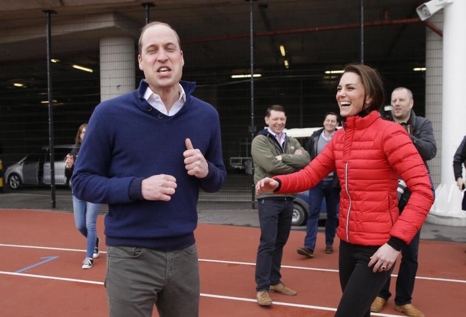 Britain's Prince William, foreground, reacts, with Kate, the Duchess of Cambridge, after running in a relay race, during a training event to promote the charity Heads Together, at the Queen Elizabeth II Park in London, Sunday, Feb. 5, 2017. (AP Photo/Alastair Grant, Pool)