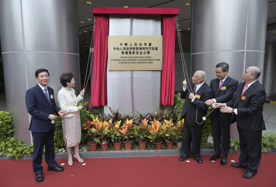 From left, Director of the Liaison Office and National Security Adviser to the Committee for Safeguarding National Security in Hong Kong Luo Huining, Hong Kong Chief Executive Carrie Lam, former Hong Kong Chief Executives Tung Chee-hwa and Leung Chun-ying and head of the Office for Safeguarding National Security in Hong Kong Zheng Yanxiong attend an opening ceremony for the China's new Office for Safeguarding National Security in Hong Kong, Wednesday, July 8, 2020. China's new national security office in Hong Kong got off to an early start on Wednesday with an official opening amidst heavy police presence. The new Chinese office in Hong Kong has taken over the Metropark Hotel, owned by the China Travel Service, in the now fashionable neighborhood of Tai Hang, close to Causeway Bay. (Hong Kong Government Information Services via AP)