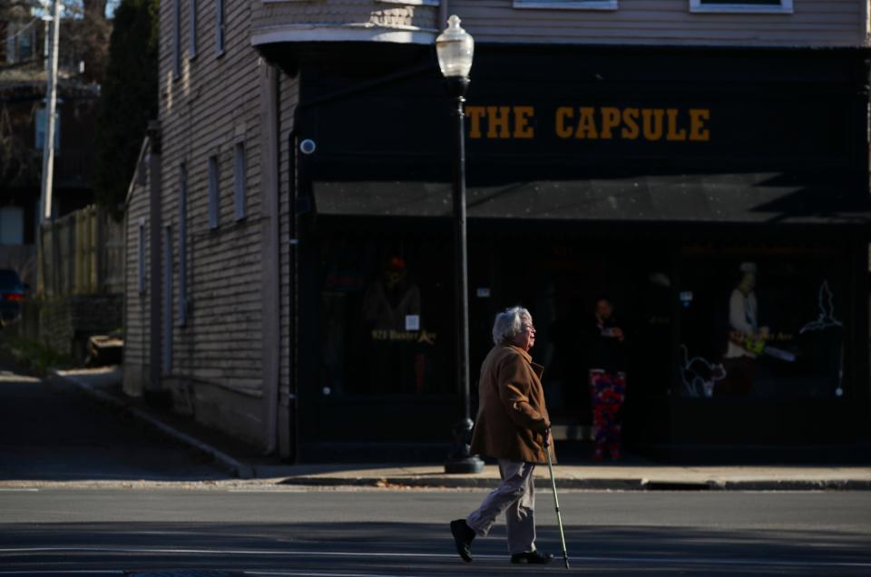 A woman walks south on Baxter Avenue in the Original Highlands on Dec. 14, 2023. Baxter Avenue/Bardstown Road has a high-density of shops, stores, bars and restaurants that are an easy walk from nearby neighborhoods.