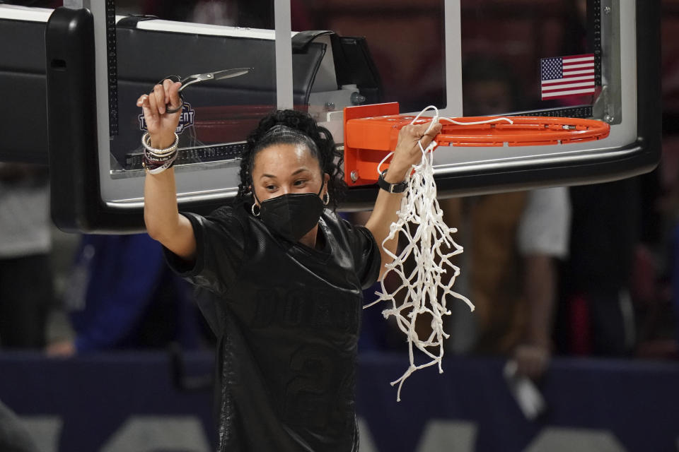 FILE - South Carolina head coach Dawn Staley cuts down the net after an NCAA college basketball game against Georgia, during the Southeastern Conference tournament final in Greenville, S.C., in this Sunday, March 7, 2021, file photo. Dawn Staley and South Carolina are back in a familiar spot: No. 1 in The Associated Press Top 25 women's basketball poll, released Tuesday, Oct. 19, 2021. (AP Photo/Sean Rayford, File)